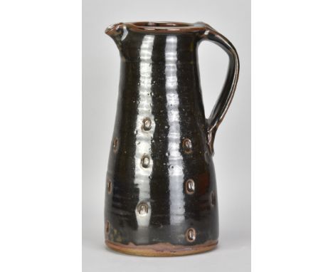 JIM MALONE (born 1946); a large stoneware pitcher covered in tenmoku breaking to kaki glaze with impressed decoration, impres