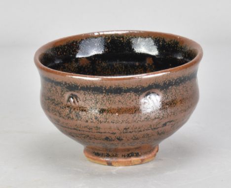 JIM MALONE (born 1946); a stoneware bowl covered in tenmoku breaking to kaki glaze with impressed decoration, impressed JM an