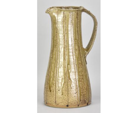 JIM MALONE (born 1946); a large stoneware pitcher covered in green ash clay glaze with incised decoration, impressed JM and B