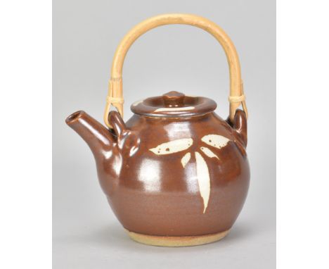 JIM MALONE (born 1946); a stoneware teapot with cane handle covered in kaki glaze with wax resist decoration, impressed JM an