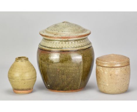 RICHARD BATTERHAM (1936-2021); a large beaten stoneware jar and cover covered in iron glaze with green ash top, height 21.5cm