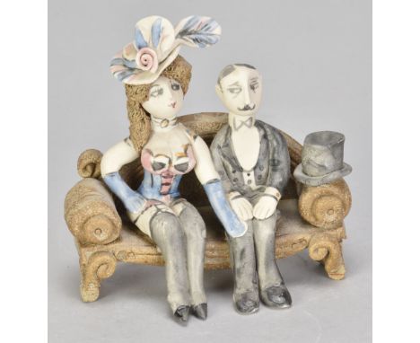 HILARY BROCK (born 1933); a small stoneware sculpture of a couple seated on a sofa, painted B mark, height 11cm. (D)Additiona