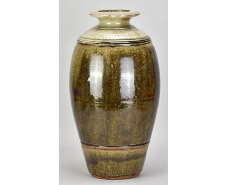 RICHARD BATTERHAM (1936-2021); a tall stoneware bottle covered in iron glaze with green ash top, height 40.5cm. (D)Additional