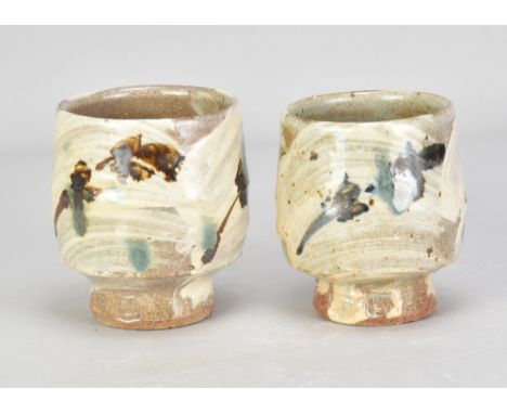 JIM MALONE (born 1946); a near pair of stoneware yunomi covered in brushed slip with iron and copper green decoration, impres