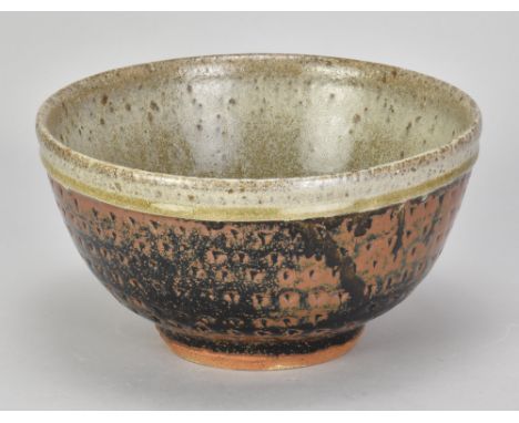 JIM MALONE (born 1946); a stoneware bowl covered in tenmoku breaking to kaki glaze with green ash rim and interior and impres