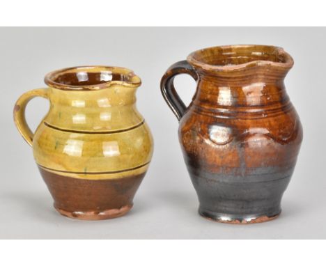 Winchcombe Pottery; a slipware jug, impressed pottery mark, height 12.5cm, and another slipware jug by a different maker (not