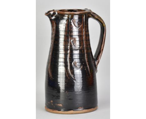 JIM MALONE (born 1946); a large stoneware pitcher covered in tenmoku breaking to kaki glaze with incised decoration, impresse