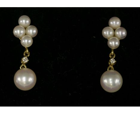 A pair of gold, cultured pearl and diamond drop earrings,by Mikimoto.  A lozenge cluster of four, peg set, cultured pearls wi