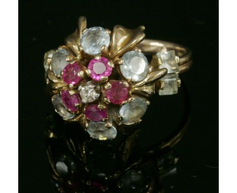 A rose gold, diamond, ruby and aquamarine cluster ring, c.1950,with an eight cut diamond, claw set to a white collet at the c