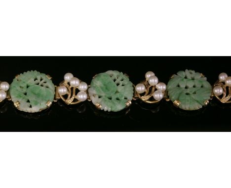 An Asian carved jade and cultured pearl gold bracelet, c.1950,with circular, carved and pierced jade plaques, claw set betwee