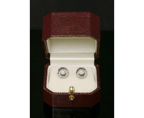 A pair of platinum single stone diamond earrings,with a brilliant cut diamond, estimated as approximately 0.18ct, rub set in 