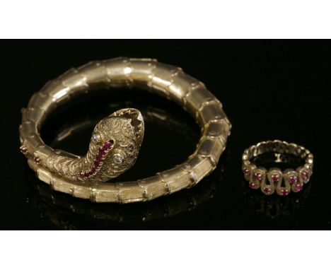 A Continental ruby and diamond set snake bangle, c.1950,the articulated and sprung bangle with a naturalistic snake or serpen