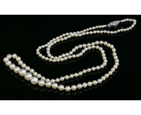 A single row graduated natural pearl necklace,with a diamond set safety clasp.  One hundred and forty-nine graduated natural 