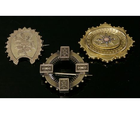 A Victorian Etruscan-style gold circle brooch,with a flat section hoop with a rectangular block at the compass points, with a
