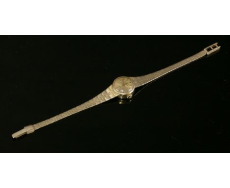 A ladies' 9ct gold Marvin 'Revue' quartz bracelet watch,with a circular champagne dial, raised back and gold batons and hands