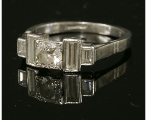 An Art Deco single stone diamond ring,with diamond set shoulders, with an old brilliant cut diamond, estimated as approximate