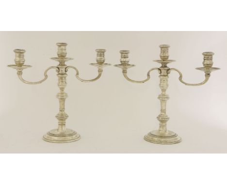 A pair of Elizabeth II silver three-light candelabra,Richard Comyns, London 1962,the baluster stems on spreading circular foo