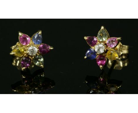 A pair of gold and sapphire cluster earrings,with a circular mixed cut light grey sapphire, claw set to the centre, surrounde