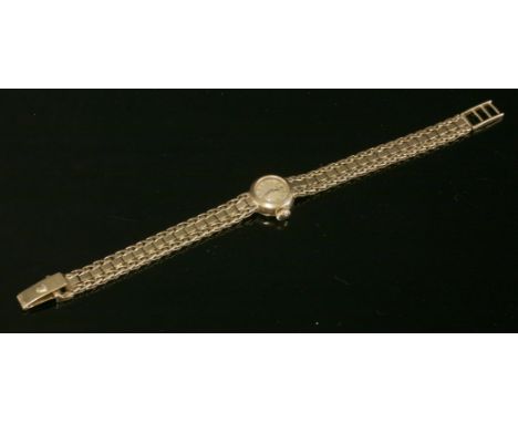 A ladies' 18ct gold Rolex mechanical bracelet watch,with a circular silvered dial with gilt hands and batons.  An integral tw