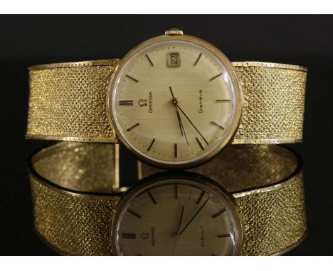 A gentlemen's 9ct gold Omega Genève mechanical bracelet watch, c.1970,with a circular champagne dial, with raised gilt batons
