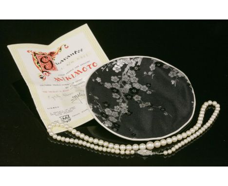 A single row graduated cultured pearl necklace,with a silver boat-shaped safety clasp.  Eighty-three graduated cultured pearl
