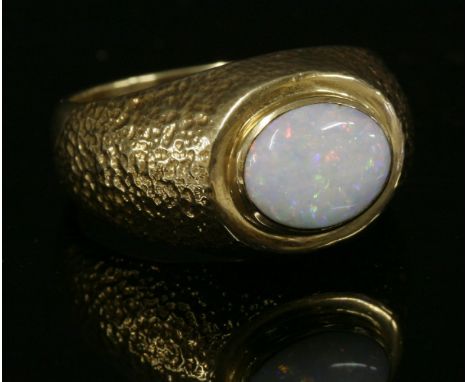 A Continental gentlemen's single stone opal ring,with an oval cabochon opal, rub set in a landscape position to a Prussian-st