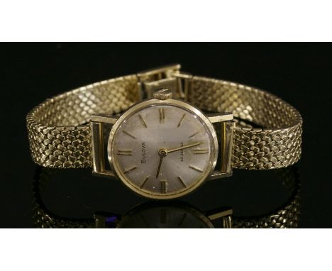 A ladies' 18ct gold Bulova mechanical strap watch,on a later gold bracelet.  Circular silvered dial with raised gilt batons a