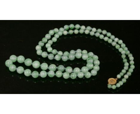 An Oriental, single row, graduated, untreated jade bead necklace, c.1920, one hundred and four graduated jadeite beads, from 