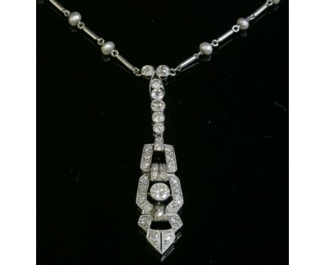An Art Deco diamond and seed pearl necklace, c.1925,with a pendant drop centrepiece.  A row of graduated old European cut dia