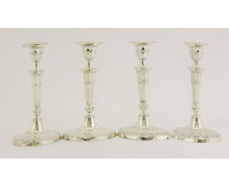 Two matched pairs of Victorian and Edwardian silver candlesticks,George Howson for Harrison Brothers and Howson, Sheffield, 1