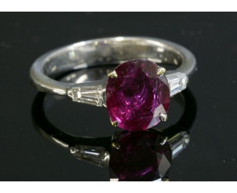 A gold single stone ruby ring,with diamond set shoulders, with an oval mixed cut ruby, estimated as approximately 1.90ct, fou