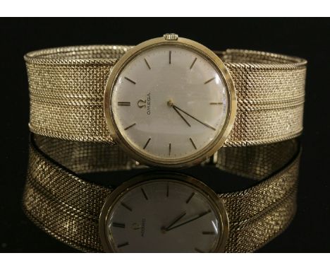 A gentlemen's 9ct gold Omega mechanical bracelet watch, c.1960,with a circular silvered dial, raised gilt batons and hands.  