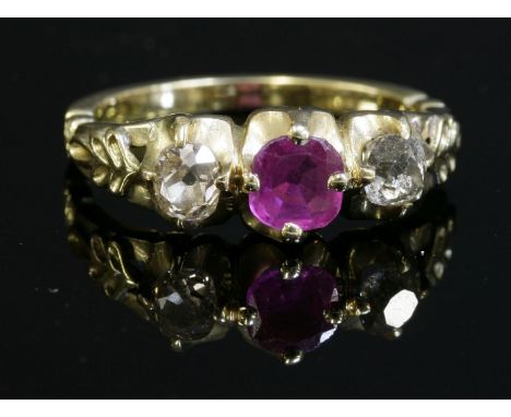 A Victorian three stone pink sapphire and diamond ring,with a cushion-shaped pink sapphire, four claw set to the centre.  An 