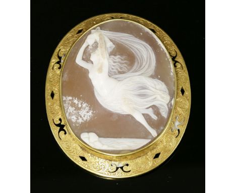 A Victorian carved shell cameo brooch,depicting a classical female figure, partially clothed in robes, holding an ewer aloft 