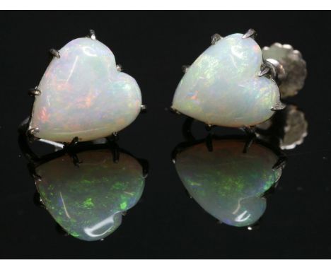 A pair of single stone opal earrings,with a heart-shaped cabochon opal, claw set to screw fittings.  Marked 9ct.  10.2 x 9.7m