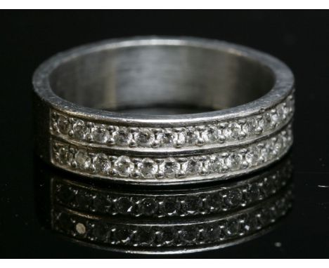A platinum two-row diamond set half eternity ring,with a flat section band, 5mm wide, grain set with two rows of brilliant cu