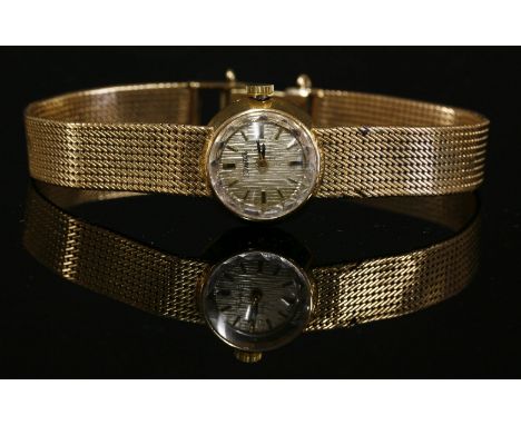A ladies' gold Duward mechanical bracelet watch,with bark textured silvered dial, raised batons and gilt and black hands.  An
