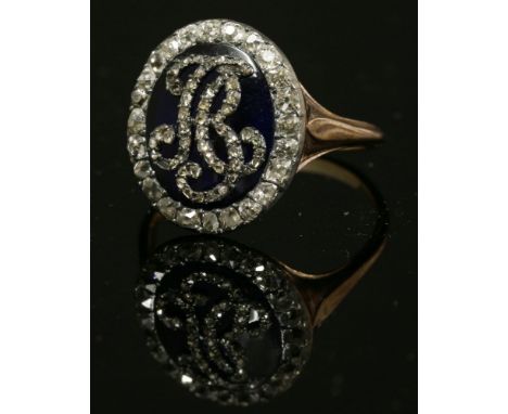 A Georgian enamel and diamond set oval monogram ring, with rose cut diamond set monogram, possibly 'AB', to a royal blue enam