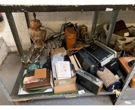 Shelf of collectables including transistor radio's, glassware, table lamp, binoculars, Beatrix Potter books etc