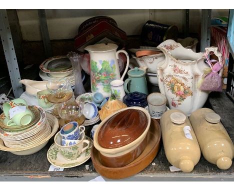 Shelf of items to include old biscuit tins, china, earthenware jugs, bed warmers etc