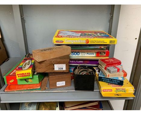 Shelf of childrens games, puzzles, dominoes etc