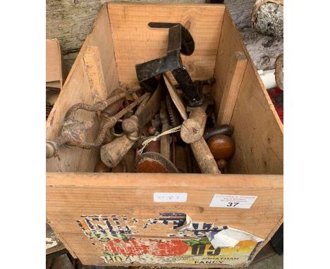 Crate of assorted tools including brass foot pumps and drills