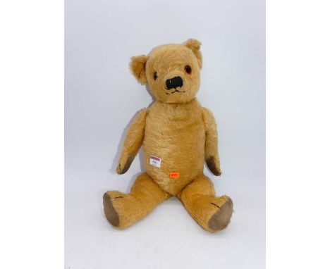 A vintage blond mohair teddy-bear, having glass eyes and adjustable limbsApprox. 50cm head to toe.Pads all look as if they ma