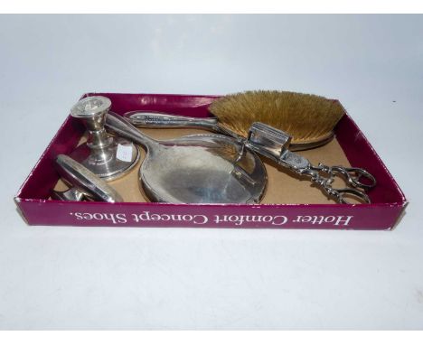 A George V silver backed two-piece dressing table set, Birmingham 1928; together with a silver dwarf table candlestick; silve