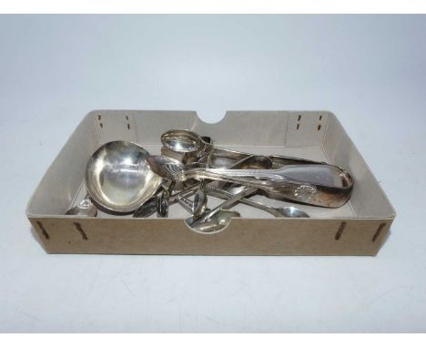 A collection of silver and silver plated flatware, to include teaspoons, sugar nips and a sauce ladle