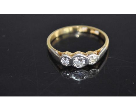 An 18ct gold and platinum diamond three stone ring, 2.1g, size M