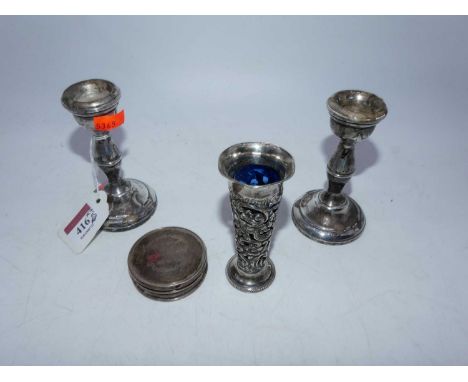 A pair of Elizabeth II silver table candlesticks, Birmingham 1971, h.10cm, loaded; together with a miniature silver spill vas