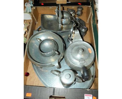 An early 20th century English pewter spot-hammered four-piece tea service, on oval tray; together with a pewter 'Conquest' ca