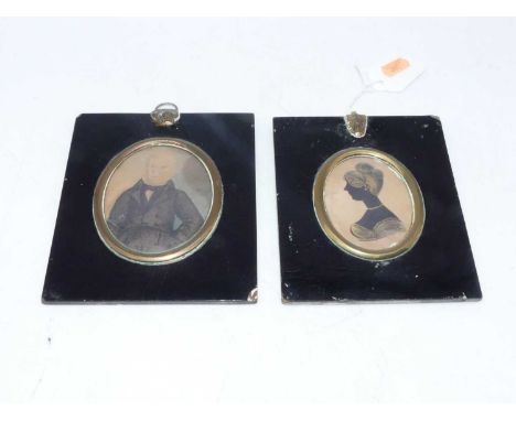 A Victorian portrait silhouette of a woman facing left, 7x5.5cm, together with a portrait of a gentleman 8x7cm