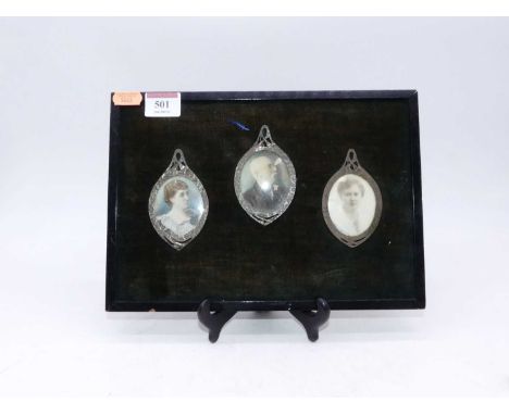 A set of three late 19th / early 20th century portrait miniatures, each within a hammer-beaten copper mount and ebonised fram